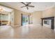Spacious living room with tile floors, fireplace, and sliding glass doors to the pool area at 1222 Starboard Ky, Tarpon Springs, FL 34689