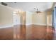 Expansive living room with hardwood floors and a double-door entry, perfect for entertaining guests at 1222 Starboard Ky, Tarpon Springs, FL 34689