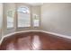 Bright office space with wood floors, three large windows, and neutral wall color at 1222 Starboard Ky, Tarpon Springs, FL 34689