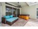 Relaxing covered patio with comfortable seating and a hot tub, ideal for unwinding outdoors at 1222 Starboard Ky, Tarpon Springs, FL 34689