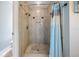 Tiled shower with built-in niche, rainfall showerhead, and mosaic tile floor at 1222 Starboard Ky, Tarpon Springs, FL 34689