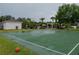 Community basketball court with a hoop, basketball, and a building to the side at 12408 Country White Cir, Tampa, FL 33635