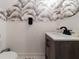 Nicely decorated powder room featuring unique wallpaper and an updated vanity at 12408 Country White Cir, Tampa, FL 33635