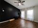 Spacious bedroom with dark accent wall, wood floors, and abundant natural light at 12408 Country White Cir, Tampa, FL 33635