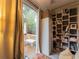 Bright room with sliding glass doors to a wooden deck and built-in storage and shelving at 12408 Country White Cir, Tampa, FL 33635