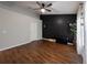 Large bedroom with wood floors, a black accent wall, and generous natural light at 12408 Country White Cir, Tampa, FL 33635