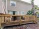 A wooden deck with a railing, offering a view of the backyard and a relaxing outdoor space at 12408 Country White Cir, Tampa, FL 33635