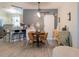 Inviting dining area featuring a stylish table, a sliding barn door, and an open view to the adjacent kitchen at 12408 Country White Cir, Tampa, FL 33635