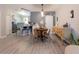 Inviting dining area featuring a stylish table, a sliding barn door, and an open view to the adjacent kitchen at 12408 Country White Cir, Tampa, FL 33635