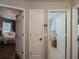 Hallway with access to a bedroom and a bathroom, all with neutral walls and white doors at 12408 Country White Cir, Tampa, FL 33635