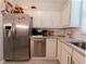 Well-equipped kitchen featuring stainless steel appliances and granite countertops with white cabinets at 12408 Country White Cir, Tampa, FL 33635