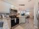 Modern kitchen with stainless steel appliances and island open to the living room at 12408 Country White Cir, Tampa, FL 33635