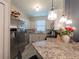 Kitchen boasting stainless steel appliances, granite countertops, and stylish pendant lights at 12408 Country White Cir, Tampa, FL 33635