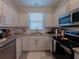 Well-lit kitchen featuring stainless steel appliances, granite countertops, and subway tile backsplash at 12408 Country White Cir, Tampa, FL 33635