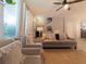 Bright and airy living room with plush seating, large windows, and a cozy atmosphere, perfect for relaxation and gatherings at 12408 Country White Cir, Tampa, FL 33635