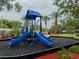 Playground with slides, a covered area, and surrounding foliage at 12408 Country White Cir, Tampa, FL 33635