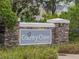 A stone and brick sign welcomes visitors to Country Chase Townhomes at 12408 Country White Cir, Tampa, FL 33635