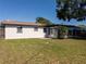 Back exterior showcasing an enclosed sunroom and tidy backyard that offers plenty of space for outdoor enjoyment at 1249 Honor Dr, Holiday, FL 34690