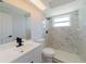 Modern bathroom features marble tile shower, white vanity with black faucet, and updated fixtures, exuding style and comfort at 1249 Honor Dr, Holiday, FL 34690