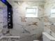 Modern bathroom features with black shower fixtures, marble tile and modern fixtures at 1249 Honor Dr, Holiday, FL 34690