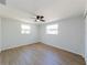 Empty bedroom features with two windows and hardwood floors providing a blank canvas for personalization at 1249 Honor Dr, Holiday, FL 34690
