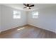 Empty bedroom features with two windows and hardwood floors providing a blank canvas for personalization at 1249 Honor Dr, Holiday, FL 34690