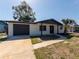Inviting single-story home featuring a fresh exterior, dark trim, and a convenient attached garage at 1249 Honor Dr, Holiday, FL 34690