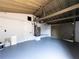 Spacious garage with painted walls and floor, exposed ceiling, and updated doors for convenience at 1249 Honor Dr, Holiday, FL 34690