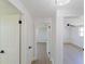 Bright hallway with white walls and doors leading to various rooms, showcasing the home's open layout and updated flooring at 1249 Honor Dr, Holiday, FL 34690