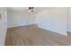 Spacious living room featuring new wood floors, neutral walls, and a modern ceiling fan at 1249 Honor Dr, Holiday, FL 34690