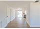 Bright living room featuring wood floors, white walls, stainless steel appliances and a door to the backyard at 1249 Honor Dr, Holiday, FL 34690