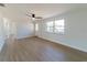 Clean and modern living room with new flooring, neutral walls, and a ceiling fan at 1249 Honor Dr, Holiday, FL 34690