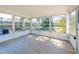 Bright sunroom filled with natural light featuring multiple windows and hardwood floors, providing a serene retreat at 1249 Honor Dr, Holiday, FL 34690