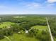 Expansive aerial view showcasing the property, surrounding woods, and ample acreage at 1253 Culbreath Rd, Brooksville, FL 34602