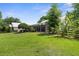 Expansive backyard with lush grass, a screened porch, and a fenced garden area offers ample outdoor enjoyment at 1253 Culbreath Rd, Brooksville, FL 34602