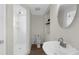 Bright bathroom with white tiled shower, modern toilet, vanity sink, and wood-look flooring at 1253 Culbreath Rd, Brooksville, FL 34602