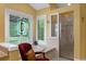 Bright bathroom featuring a soaking tub, stained glass window, glass shower, and yellow walls at 1253 Culbreath Rd, Brooksville, FL 34602