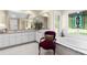 Bathroom features a luxurious soaking tub, stylish white vanities and cabinetry, and an elegant accent chair at 1253 Culbreath Rd, Brooksville, FL 34602