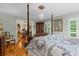 Spacious bedroom featuring four-poster bed and gleaming wood floors at 1253 Culbreath Rd, Brooksville, FL 34602