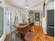 Bright dining area featuring a rustic wooden table, bench, and adjacent doors to outdoor light at 1253 Culbreath Rd, Brooksville, FL 34602