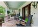 Inviting front porch featuring a brick floor, rocking chairs, and a porch swing at 1253 Culbreath Rd, Brooksville, FL 34602
