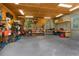 Plywood ceiling and fluorescent lights in the garage, featuring shelving, a workbench and tools at 1253 Culbreath Rd, Brooksville, FL 34602