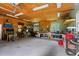 Inside the workshop garage features a plywood ceiling, fluorescent lights, shelving, and work benches at 1253 Culbreath Rd, Brooksville, FL 34602