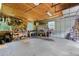 Inside of the garage featuring a plywood ceiling, fluorescent lights, shelving, and a workbench at 1253 Culbreath Rd, Brooksville, FL 34602
