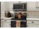 Modern kitchen featuring stainless steel appliances, light countertops, and classic white cabinetry at 1253 Culbreath Rd, Brooksville, FL 34602