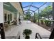 Expansive screened patio with tiled flooring, comfortable seating, and lush landscaping at 1253 Culbreath Rd, Brooksville, FL 34602
