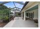 Expansive screened patio with seating, dining area and views of lush landscaping at 1253 Culbreath Rd, Brooksville, FL 34602