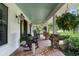 A long porch with stone pillars and hanging plants offers a relaxing outdoor space with nice views at 1253 Culbreath Rd, Brooksville, FL 34602