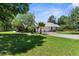 Sprawling green lawn with a long driveway and a well-maintained yard presents a picturesque country setting at 1253 Culbreath Rd, Brooksville, FL 34602