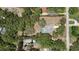 Aerial view of property lines showcasing a single-Gathering home with mature trees and a screened in swimming pool at 12722 Oak Tree Dr, Hudson, FL 34667